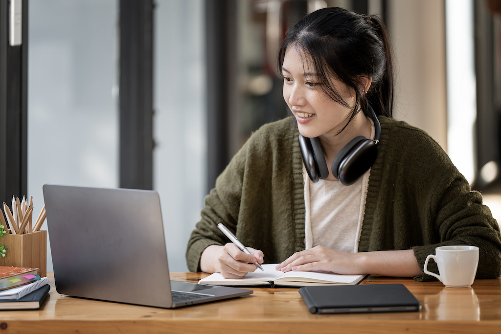 A lady wearing headphones learning